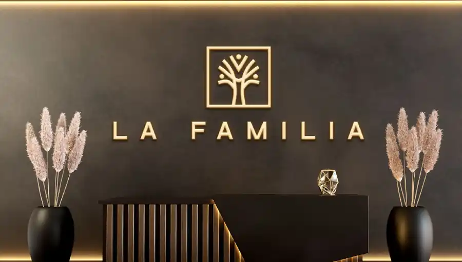 La Familia reception wall with gold logo